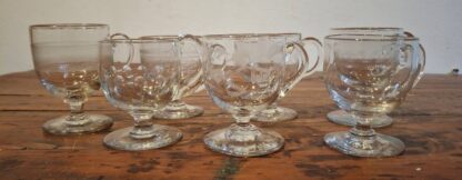 LOT 94 (25933) Est R500 to R1500 – An Assembled Collection of 12 x Assorted and Graduated Late 19th Century Cape Woodstock and Victorian Glass footed Custard Cups