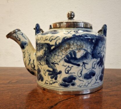 LOT 67 (3199114) Est R500 to R1500 – A 20th Century Oriental Blue and White Swing-handle Teapot with later Sterling silver mounts