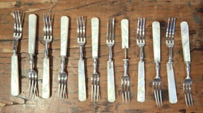 LOT 10 (32181152) Est R3000 to R6000 – 12 x Elizabeth II Silver and Mother-of-pearl hafted Fruit Forks and 12 x matching Fruit Knives (24pcs)