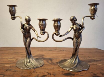 LOT 33 (32404) Est R5000 to R15000 – An Elegant Pair of Early 20th Century German WMF Art Nouveau Oxidised and Electroplated Pewter Figural Two-light Candelabras circa 1906